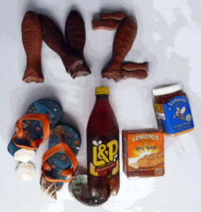 4. Title: “Sweet As” Photographer Level: Salon Score: 83 – Highly Commended This image is bursting with nostalgic charm and unmistakable Kiwi flavour — it’s bold, humorous, and unapologetically kitsch in the best possible way. The composition cleverly forms “NZ” from chocolate fish (a brilliantly irreverent touch), and surrounds the text with a collection of unmistakably Kiwiana icons: L&P, jandals, Airborne honey, Edmonds yeast, pāua shell and beach finds. It’s a visual celebration of what makes New Zealand, well... sweet as. The top-down layout is tidy and effective, presenting each object clearly and with a sense of symmetry and colour balance. The use of a white background helps the items pop and contributes to the graphic, poster-like quality. There's a playful energy here that communicates joy and identity without needing to take itself too seriously — exactly what many Kiwiana themes aim for. What elevates this image is the photographer’s confident embrace of the theme with humour and style. One suggestion for further refinement would be to explore lighting a little more deliberately — the current light feels slightly flat, and a more controlled or directional setup could enhance contrast and depth. That said, this is an engaging, well-constructed and entertaining piece that ticks the brief with flair